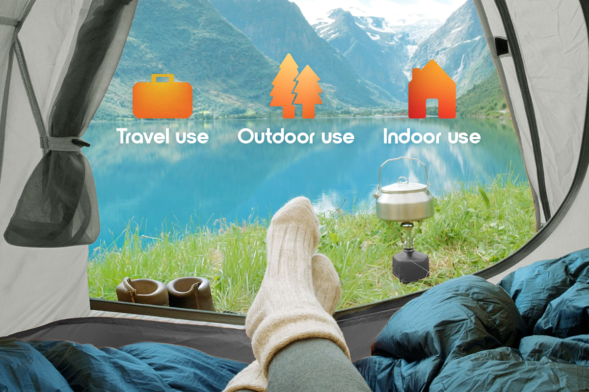 Lifestyle photography of a woman using the Cozi portable air mattress while camping.