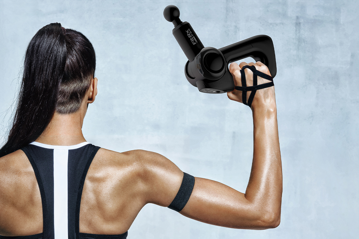 Woman using FitRx Pro multi-angle massager