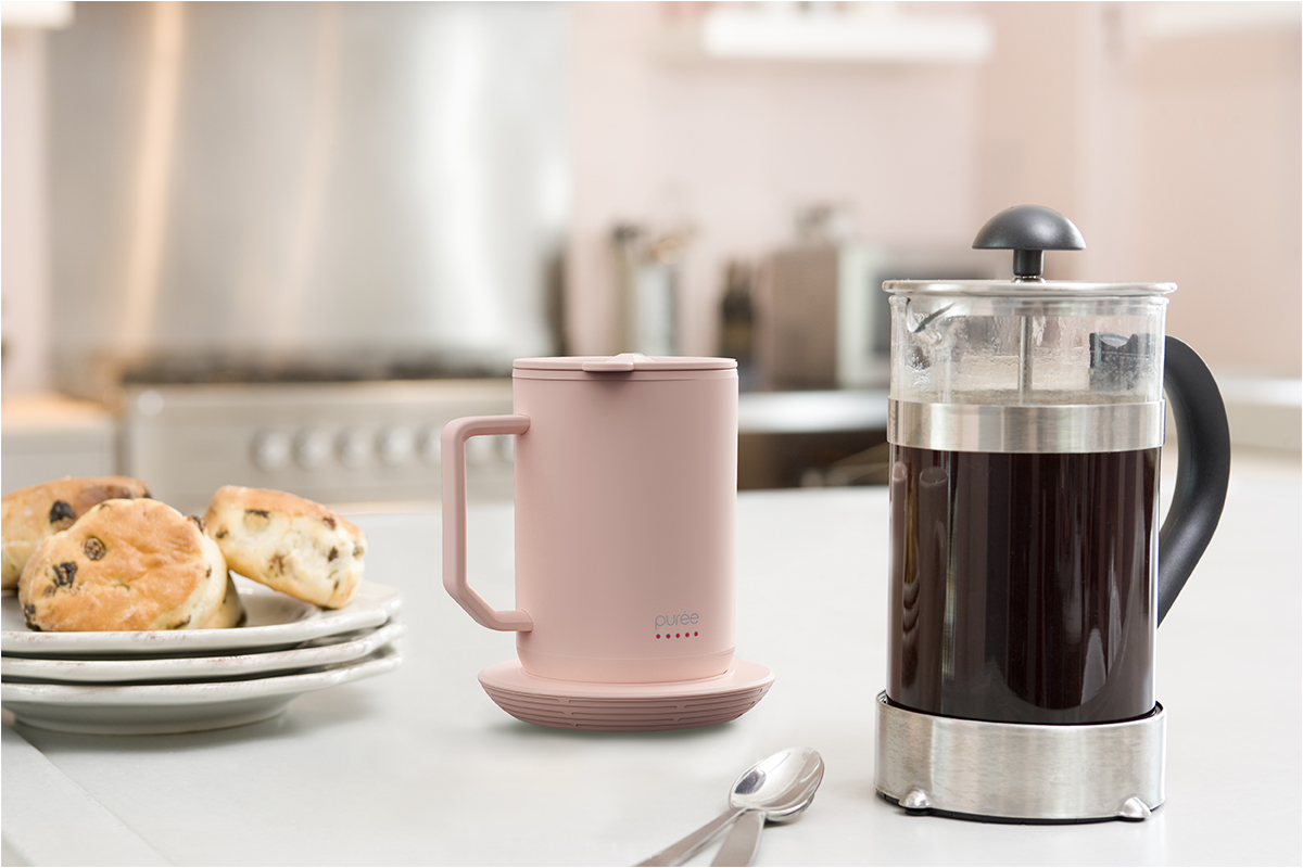 Purée warming mug on kitchen counter with pot of fresh brewed coffee