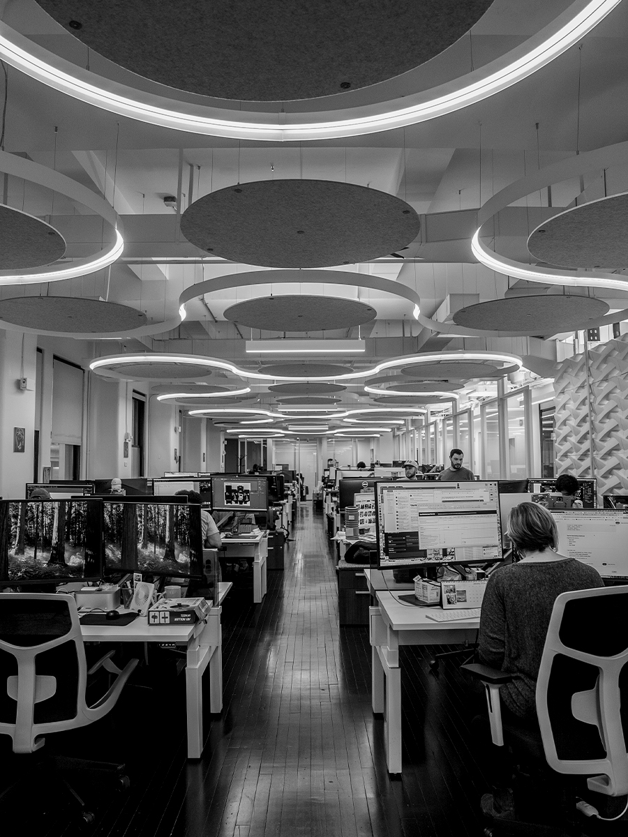 Large open-plan StudioZ creative agency office in NYC with modern lighting.