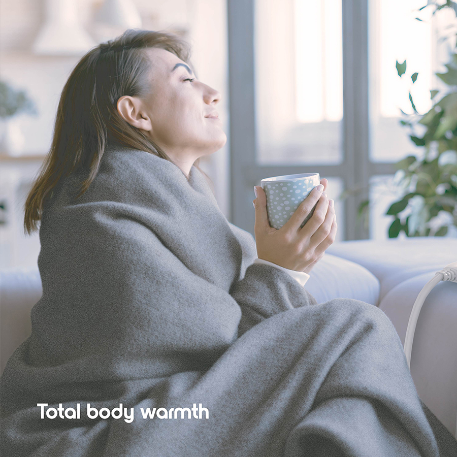 Woman using Cozi Heated Throw Blanket